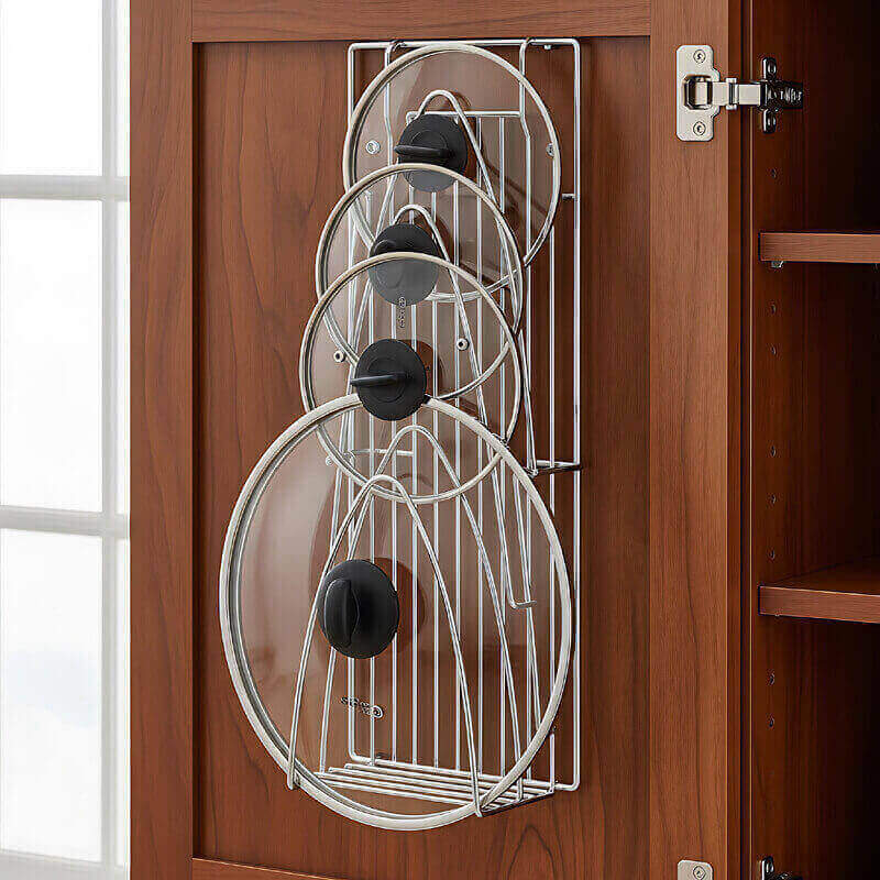 Pot lid organizer mounted inside cabinet door keeping lids organized and accessible