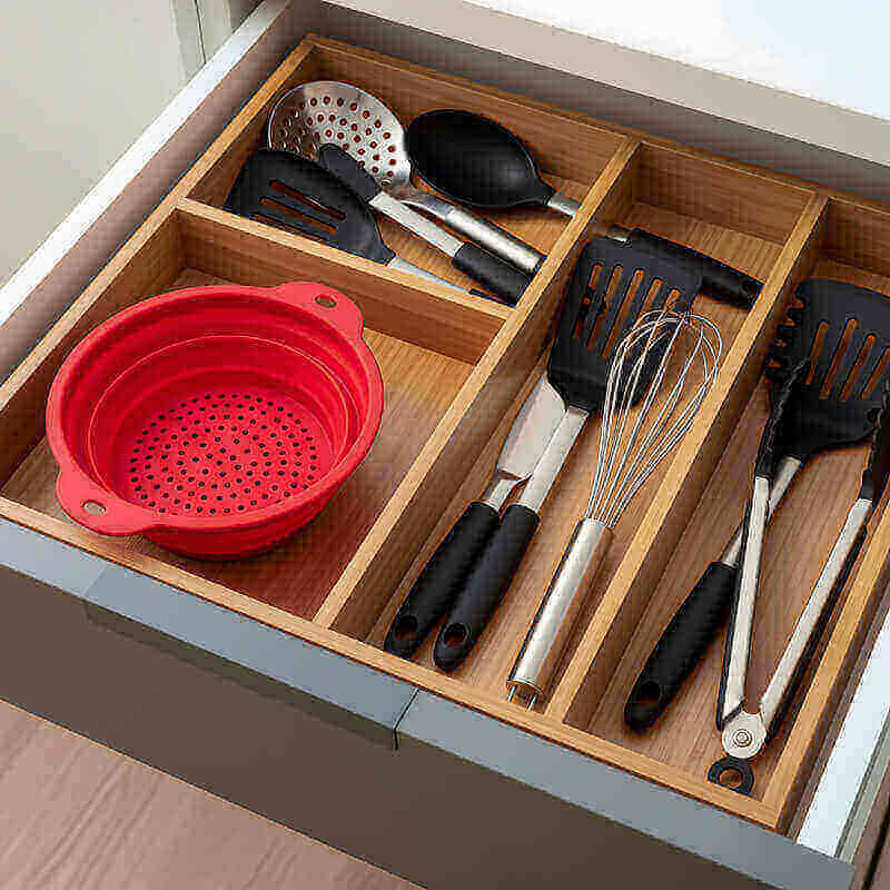 Collapsible silicone colander folded flat in kitchen drawer saving cabinet space