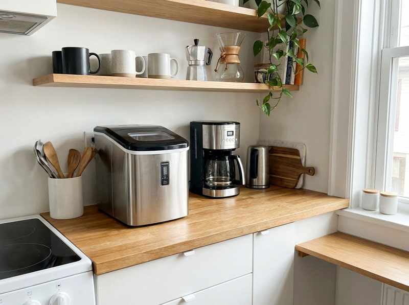 Compact ice maker on small kitchen counter next to coffee maker size comparison