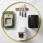 Kitchen product design small spaces example showing modular nesting prep system, magnetic knife strip, and compact appliances on white counter with measuring tape