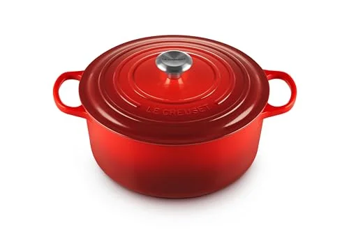 Le Creuset vs Staub Dutch ovens side by side on a kitchen counter, showing their different enamel finishes and lid designs.